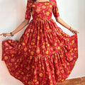 Red Floral Dress - Model twirling lifestyle shot