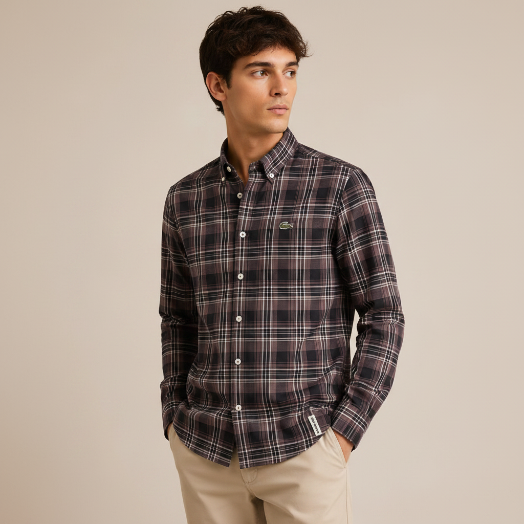 Man wearing dark charcoal plaid shirt against beige studio wall