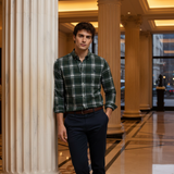 Man wearing green plaid shirt in luxury hotel lobby