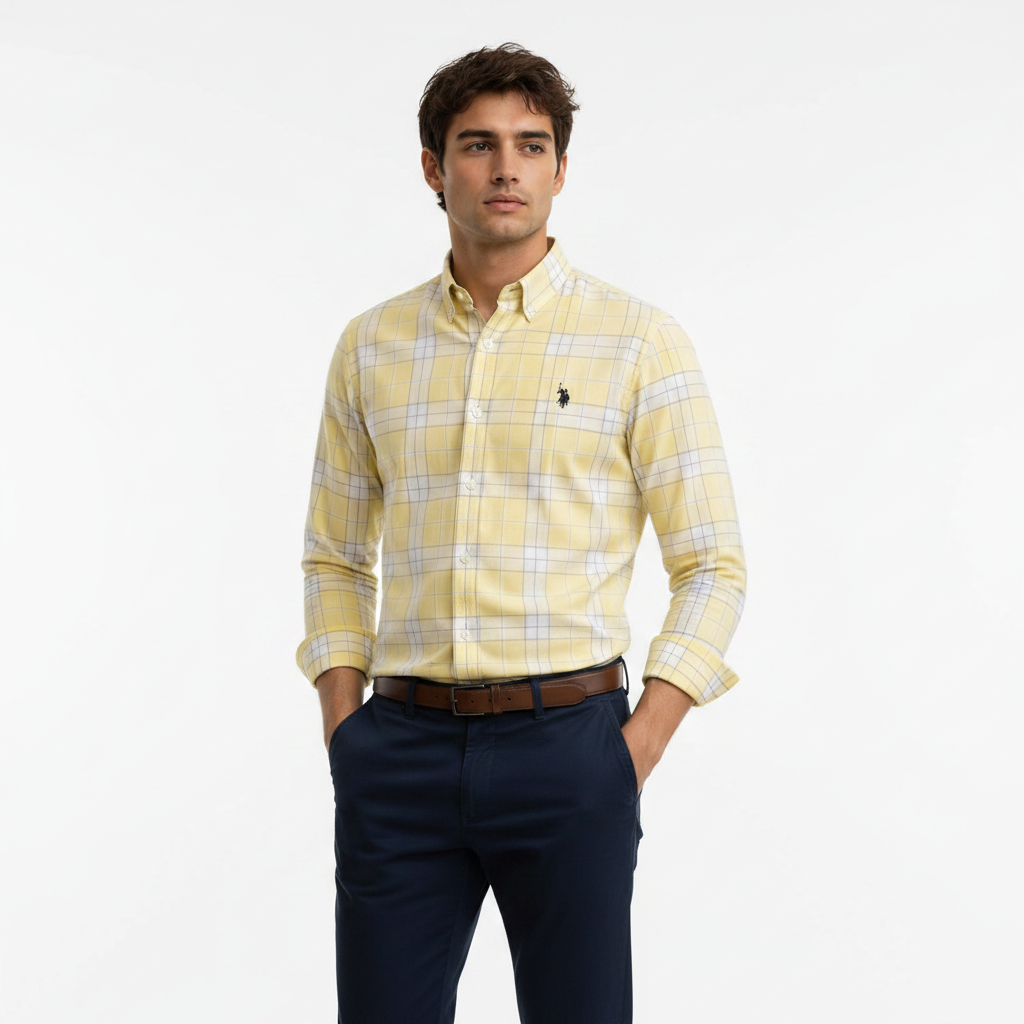Man wearing yellow plaid shirt against white studio background