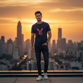 Man wearing navy blue Rare Rabbit tee on rooftop at sunset