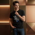 Man wearing black rose graphic tee against bronze metallic geometric wall
