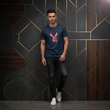 Man wearing navy blue Rare Rabbit tee against dark geometric luxury tile wall