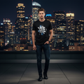 Man wearing black rose graphic tee on city rooftop at night