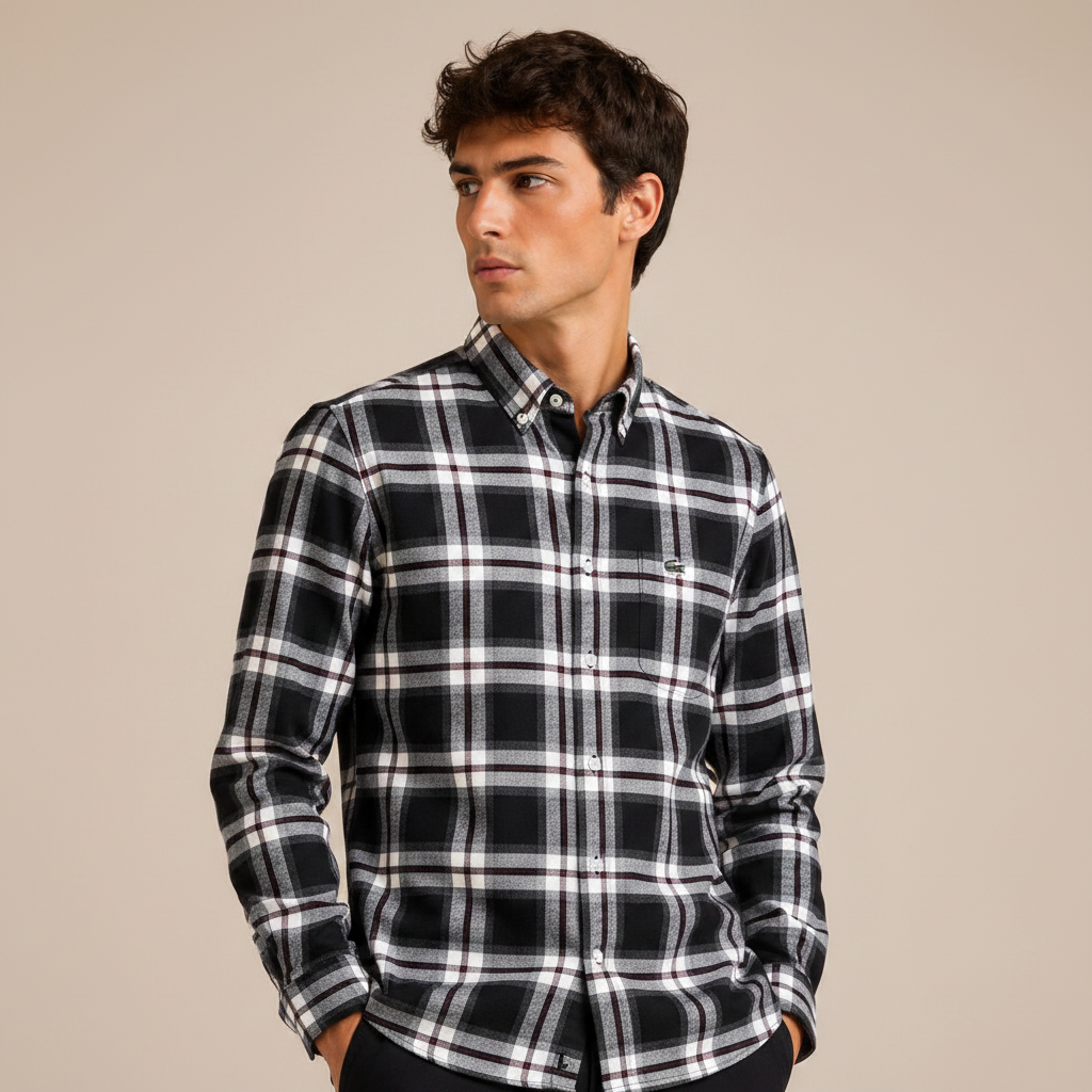 Man wearing black white plaid shirt against beige studio background